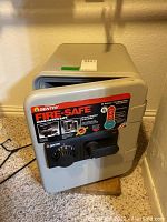 Front view of Sentry fire safe showing combination dial, handle, and fire-resistant certification label.