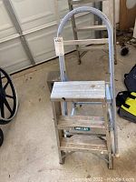 Aluminum Keller 2 ft light duty step stool with rounded hand grip and two steps, light usage visible.