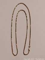 Full length chain laid flat showing twisted rope design and lobster clasp