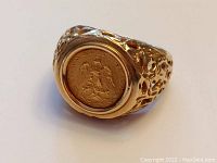 Angled front view showing textured band and bezel-set coin