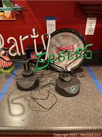 Two electric bar neon lights (Philadelphia Eagles logo and 'Party') with Coors Light wall clock behind on counter.