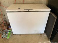 Front exterior view of white chest freezer showing overall shape and condition