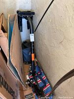 Photo of U-Haul bike rack and trailer hitch showing black metal construction, bike holding pads, and ball mount for trailer hitch.