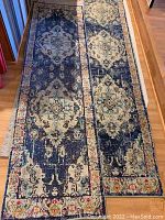 Pair of Safavieh Monaco navy light blue runner rugs laid out on hardwood floor, showing full length and pattern details
