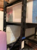 Close-up of heavy duty metal shelving frame showing metal posts and wire mesh shelf.