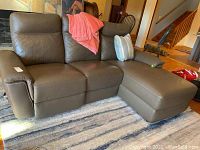 Overall front view of three-seat sofa with attached chaise