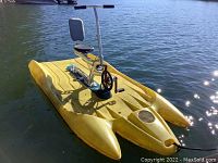Yellow water bike afloat on lake.