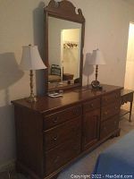 Front view of full dresser and attached mirror with lamps on top