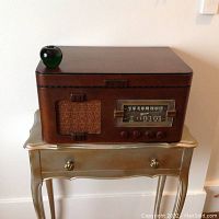 Front view of the Marconi radiogram showing wooden cabinet, speaker grille, tuning dial, and control knobs.