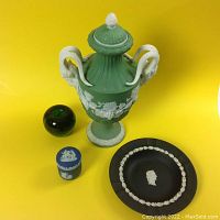 Three Wedgwood pieces shown together for size and style comparison with a green glass apple as reference.