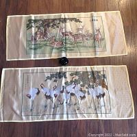 Front view of both panels laid side by side on hardwood floor with size reference object.