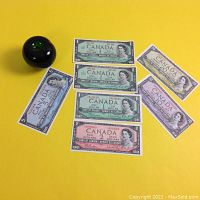 All notes laid out on yellow background with green glass apple for scale.