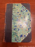 Front cover of one volume showing half-leather binding and marbled paper boards