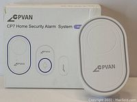 White CPVAN CP7 Home Security Alarm System box with one large white oval alarm panel Flash hub receiver, one white transmitter doorbell button with blue ring, and two slim white door/window sensors displayed in front.