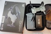 Box and unboxed contents including HS510 drone, carrying case, accessory kit