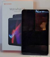 Photo showing the Vankyo MatrixPad S8 tablet in front of its retail box. The box shows the tablet's display and branding.