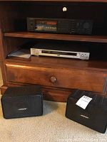 Onkyo TX-80 stereo tuner amplifier on wooden shelf with Sony DVP-NS415 DVD/CD player below and Bose mini speakers on carpet in front