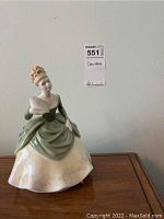 Front view of Royal Doulton Soire figurine showing lady holding fan, green and cream dress.