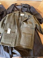 Three jackets laid out flat, front view