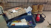 Overall view of tackle box, boots, and fire extinguisher showing the full lot