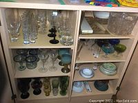 Overview of left and right cabinet shelves showing assorted glassware and dishes