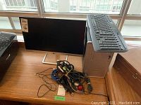 Top view of the lot showing HP desktop tower on table with Logitech keyboard on top, HP monitor, assorted cables and mouse