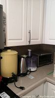 Black & Decker kettle, West Bend vintage coffee pot, Braun food processor, Breville toaster oven on counter, all untested.