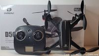 Front view of Deerc D50 drone, controller and box showing full lot contents and condition