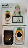Box and contents showing DRAGON TOUCH Baby Monitor E40 including pineapple-shaped camera and handheld display monitor