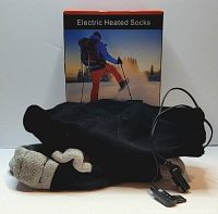 One pair of black and grey electric heated socks, showing cables and controller device in front of original product box.