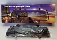 Full-size rear view mirror with integrated night vision dash camera on packing box with cityscape at night, product sealed in plastic wrap with mounting straps shown.