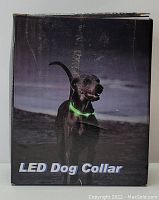 Box showing image of black dog wearing a glowing green LED dog collar at night. Box labeled 'LED Dog Collar'.