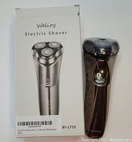 Photo of Weliry BY-1750 Electric Shaver alongside its packaging box