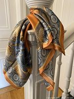 Silk scarf hanging, showing texture and pattern with natural light.