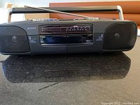 Front view of the Sony black boombox with dual tape decks and radio display.