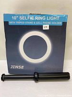 Box of a 10 inch Selfie Ring Light from JINSE with an adjustable tripod stand displayed in front of it