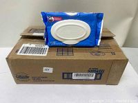 Eight-pack box of Cottonelle flushable wipes with one open pack on top.