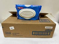 Eight-pack box of Cottonelle flushable wipes with one blue pack of wipes with plastic flip lid placed on top of the box showing product and packaging details