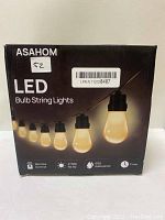 Front view of the Asahom LED Bulb String Lights box showing product name, image of bulbs, and key features such as remote control, 2700K color temperature, IP65 waterproof rating, and timer.