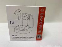 Photo of the front of the box showing Enacfire G20 wireless earbuds image and branding.