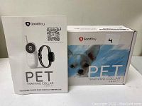 GoodBoy Pet Training Collar G880V retail boxes showing a small dog image and remote control with collar device.