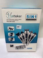 Photo of front of the box showing Hatteker 5 in 1 rechargeable hair clipper set with model number RFC-5918 and features such as lock-in length settings and USB charging
