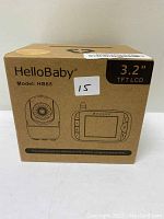 Box of HelloBaby video baby monitor model HB65 showing front panel illustration with camera and monitor units.