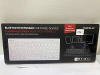 Photo of Macally Bluetooth slim keyboard box showing front label with product name, features, and image of keyboard.