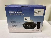 Box of the remote night light projector showing various lighting modes and features along with remote control image.