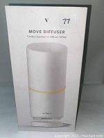 Photo of the product box showing the Vitruvi Move Cordless Essential Oil Diffuser in white color.