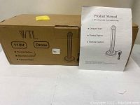 Photo of the original product box showing WTL branding, 110V, Ozone label, timing and remote control features, and an illustration of the lamp.