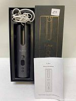 Boxed YaPoY wireless automatic hair curler with charging cable coiled beside it and instruction manual placed in front.