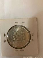 Reverse side of 1965 Canadian 50 cent coin showing Canadian coat of arms.