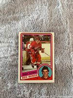 Front view of the 1984-85 Topps Steve Yzerman rookie card #49 showing player in action and portrait.